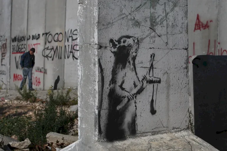 Banksy, the Anonymous Artist with Messages that Confuse Authorities and Justice for Palestinians